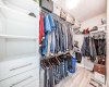 Huge walk-in closet with custom shelving.