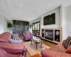 Lower level sitting area with built-in bookcase and gas fireplace