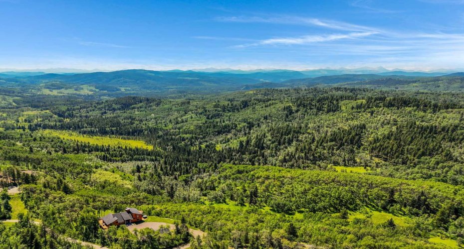 Aerial view showing house and Kananaskis beyond