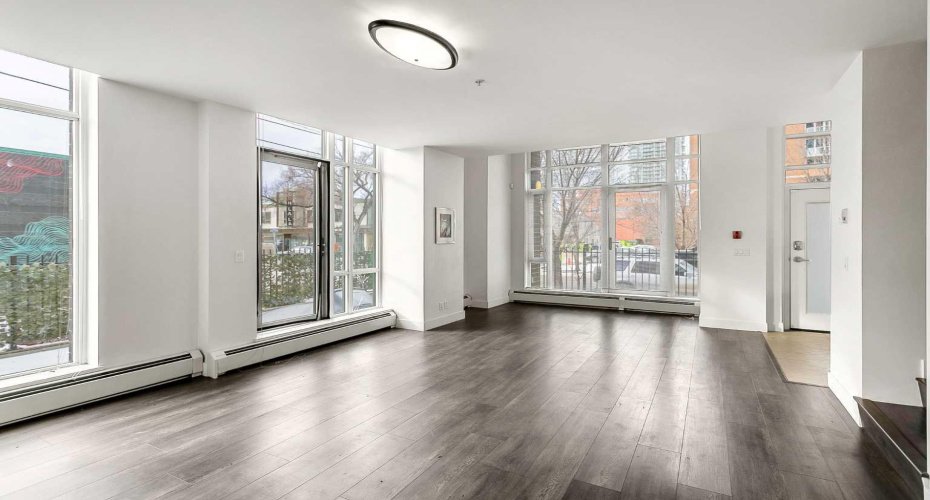 Open concept main floor with floor to ceiling windows.