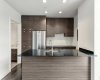 Kitchen features stainless steel appliances, quartz counters & ample cabinet space.