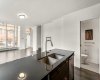 Kitchen features stainless steel appliances, quartz counters & ample cabinet space.