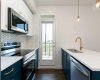Beautiful golden hardware paired with rich blue cabinets adds a bold and elegant touch to the kitchen