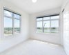 Spacious bedroom with abundant natural light and stunning views