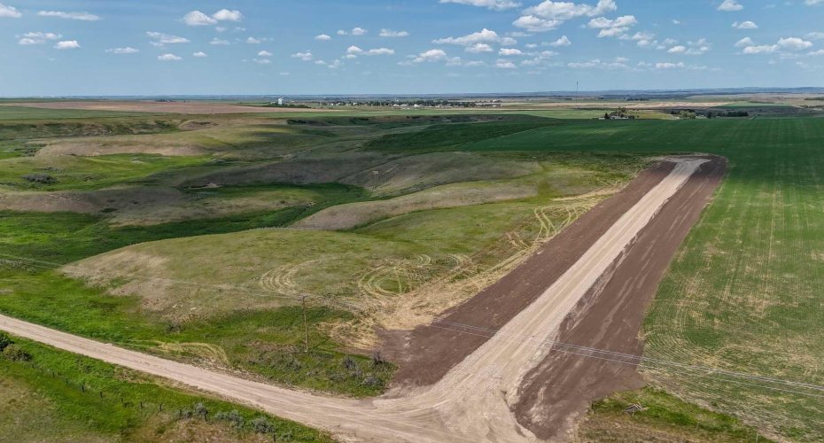 Drone view photo of acreage with Coulee vista views, Prairies and overlooking Arrowwood Creek.