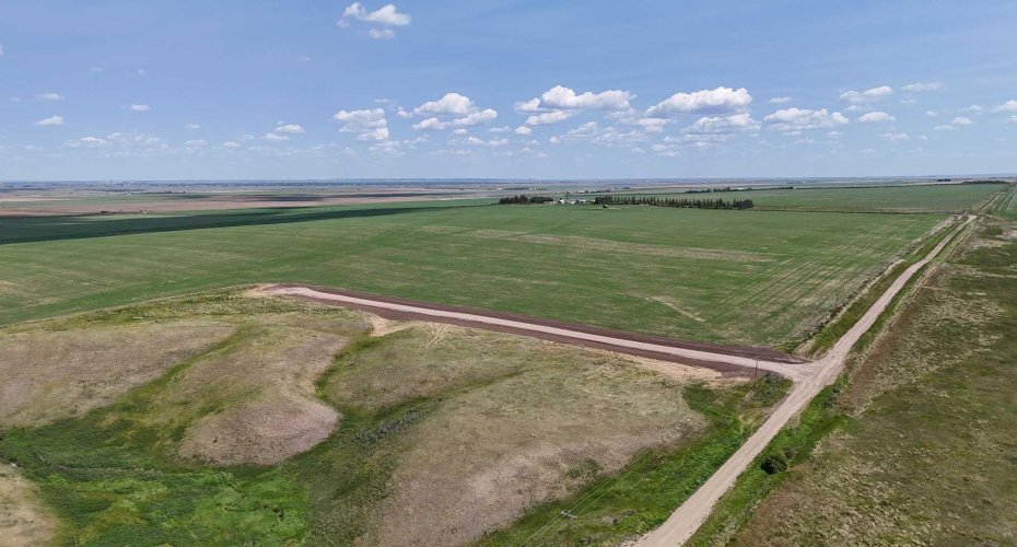 Drone view of property surrounded by prairie lands.