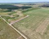 Drone view of property surrounded by prairie lands.