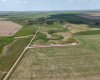Drone view of property surrounded by prairie.