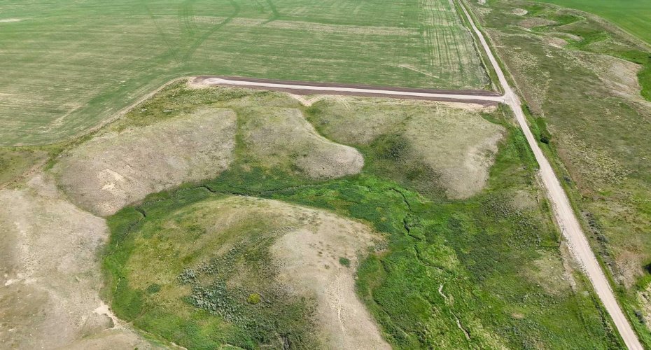 Drone view of acreage with coulee vista views and creek views.