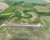 Drone view of acreage with coulee views, creek views and surrounded by prairie.