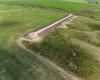Drone view of entrance into acreage and surrounding prairie lands.