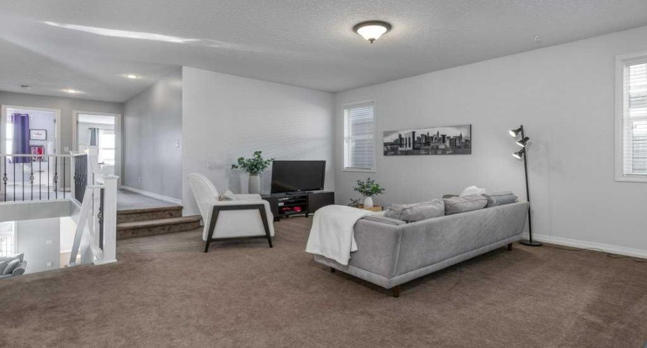 A spacious bonus room designed for real life—perfect for family movie nights, a kids’ hangout, or a comfortable secondary living area.