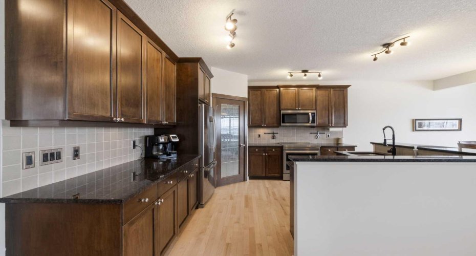 Rich cabinetry with undermount lighting.