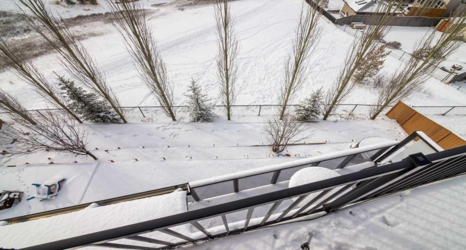 Deck off the primary suite overlooking the yard.