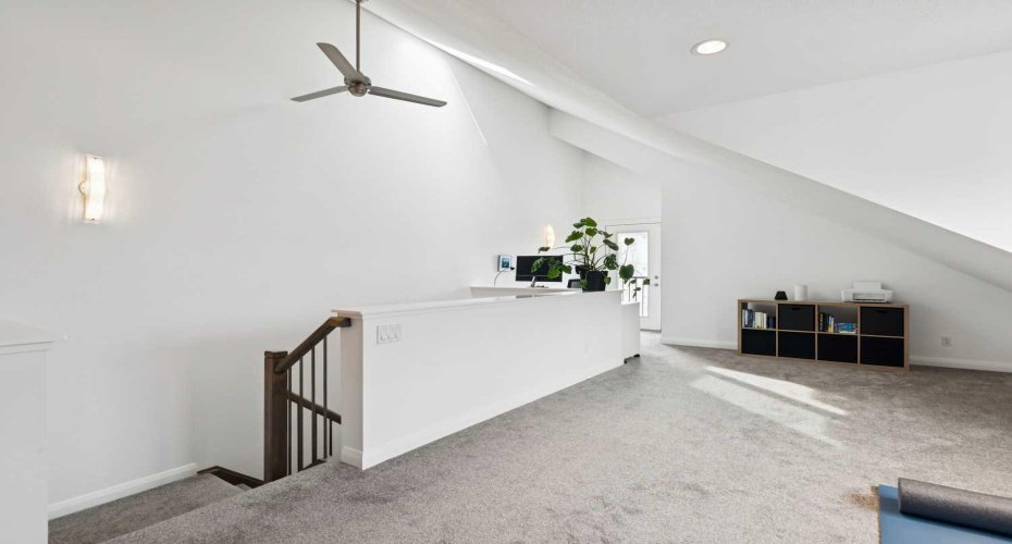 Bright loft space with vaulted ceilings and skylight