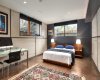 Basement bedroom has oversized windows for natural light