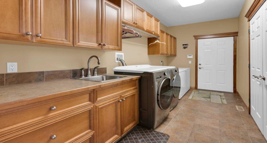 laundry is located on the main with built in shelving  and sink