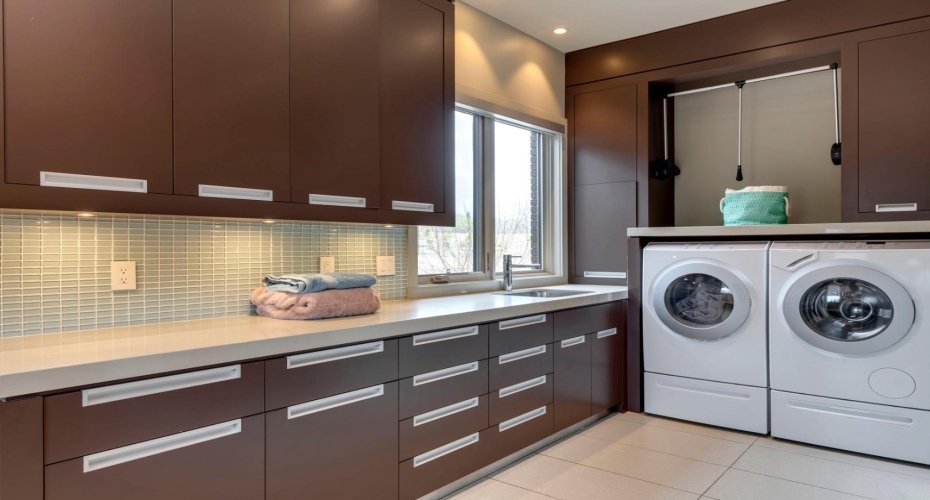 Convenient laundry with ample built-ins, sink and hanging rack.