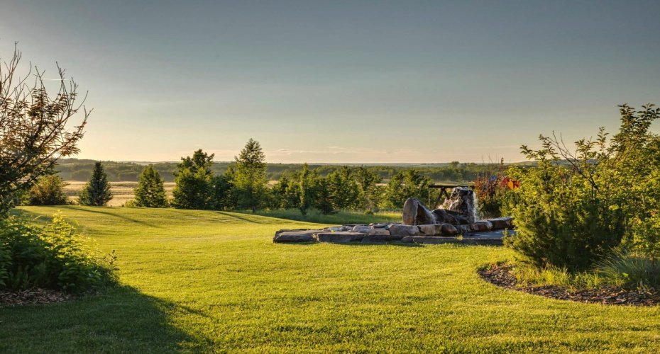Stunning landscaping includes a beautiful water feature