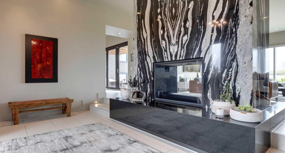 A stunning two-sided fireplace creates a dramatic focal point while adding warmth and ambiance throughout the space.