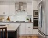 White Kitchen with Upgraded Appliances, Range Hood, Gas Cooktop, Built-In Oven & Microwave, with Quartz Counters
