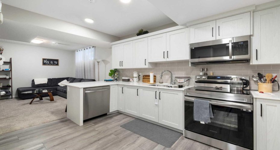 Full kitchen and living room in this basement secondary suite