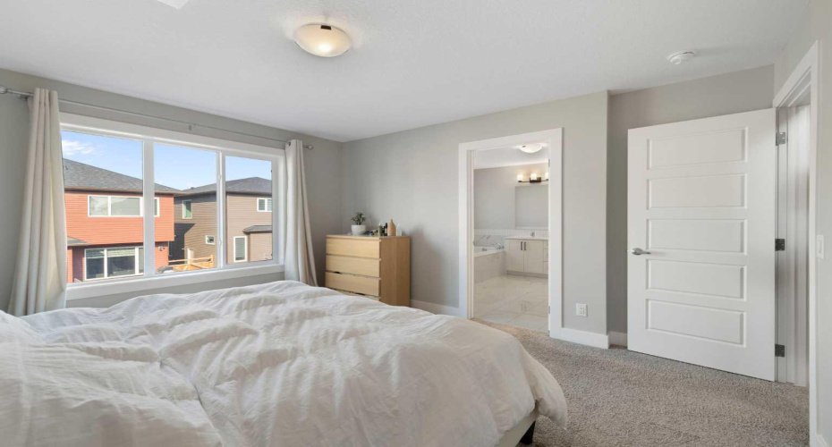 Primary bedroom view to beautiful ensuite with walk-in closet