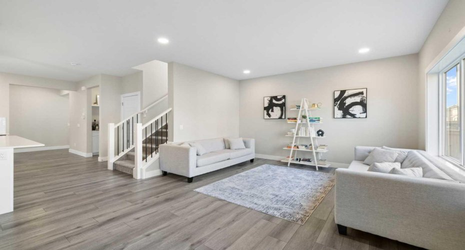 Bright living room with high ceiling and luxury vinyl plank flooring