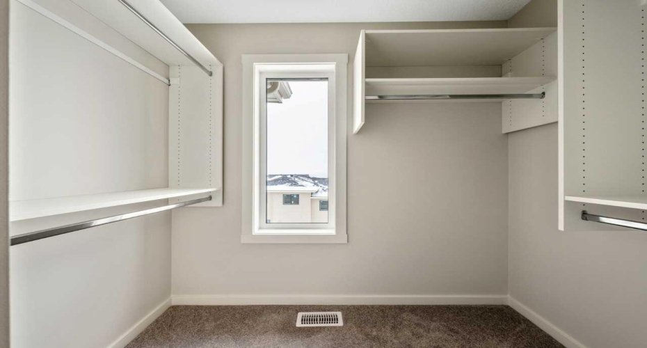 Bright primary walk-in closet