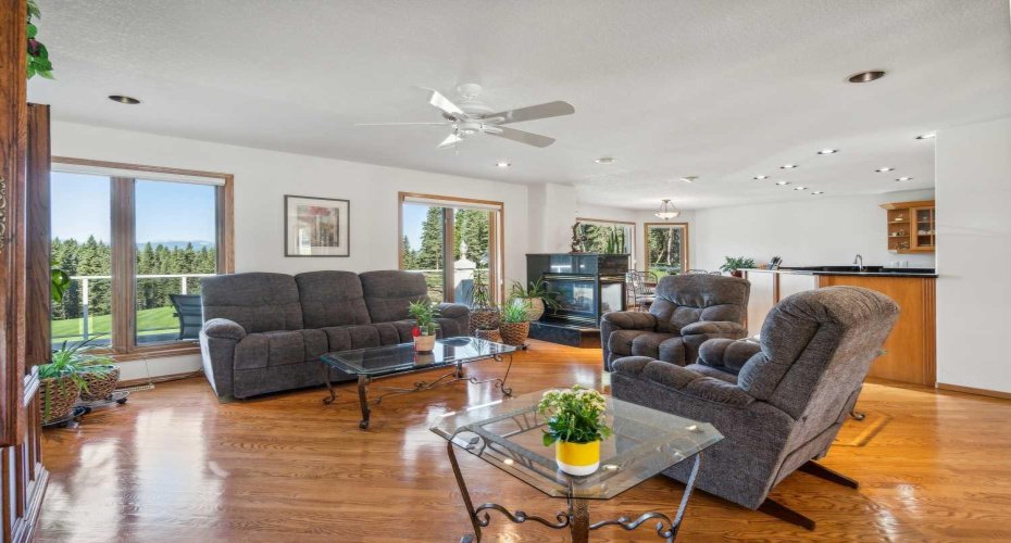 Living room with 3 way fireplace and eating nook beyond
