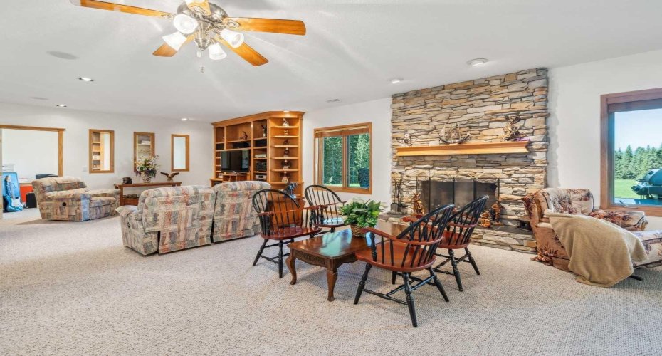Sitting area in front of central ledgestone fireplace