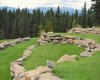 Close up of tiered sandstone walls, mountains beyond