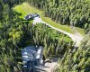 Aerial view showing shop and outbuildings tucked into the trees