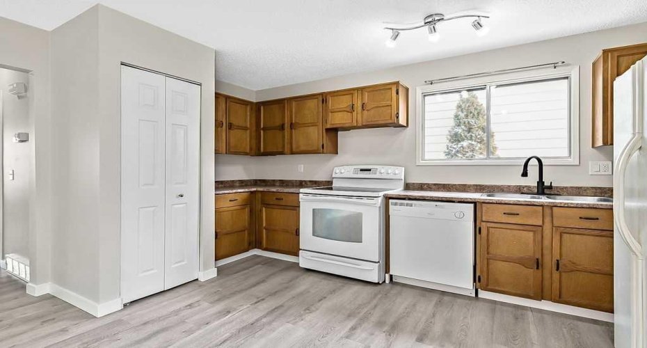The kitchen flows easily toward the dining area and backyard access, ideal for everyday meals and summer barbecues on the deck. The utility closet is also located here.