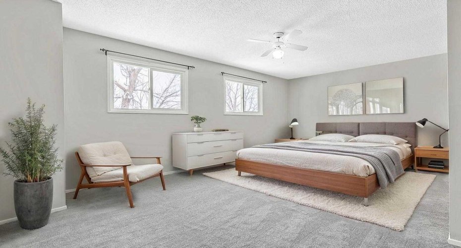 Virtually staged primary bedroom, which easily accommodates a king-size bed and offers a calm, comfortable retreat.