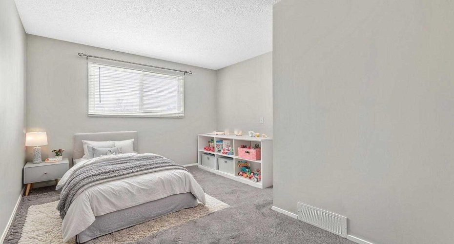 Virtually staged 3rd bedroom that works beautifully for children, guests, or a dedicated workspace.