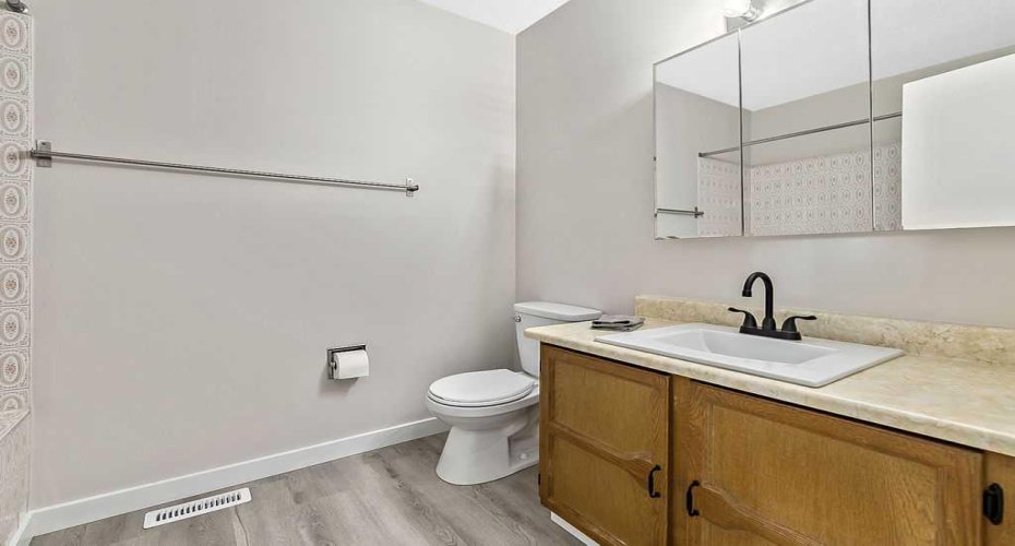 The full bathroom features an updated sink and matte black plumbing fixtures for a refreshed, modern look.