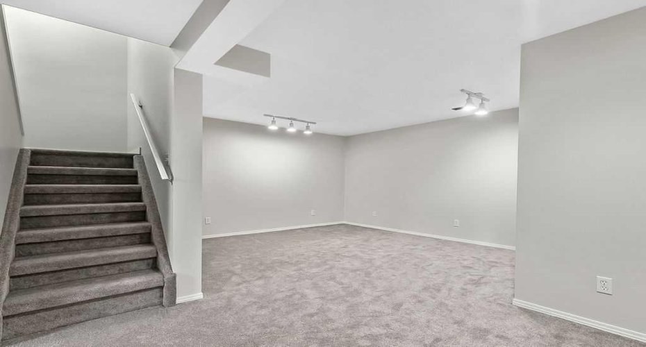 The developed basement provides a comfortable family room perfect for movie nights, relaxing, or gathering with friends.