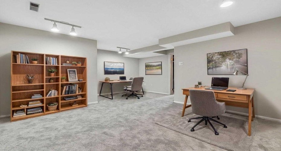 Virtually staged basement as a work-from-home space or study zone.