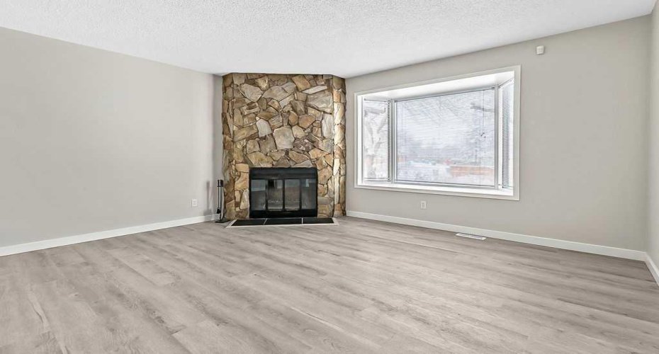Fresh paint, new luxury vinyl plank flooring, and a clean modern palette make this living space feel bright, open, and move-in ready.