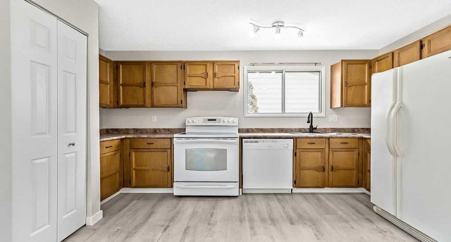 Updated matte black fixtures and refreshed hardware add a modern touch to this functional and well-laid-out kitchen.