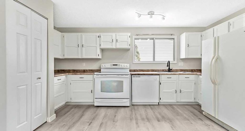 Virtually staged with updated white kitchen.