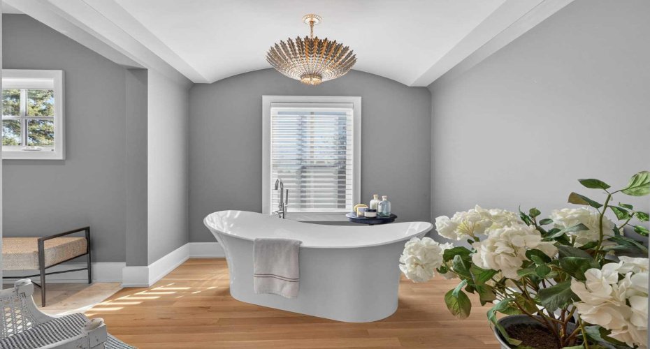 Freestanding resin soaker tub — the centerpiece of this spa-inspired primary ensuite.