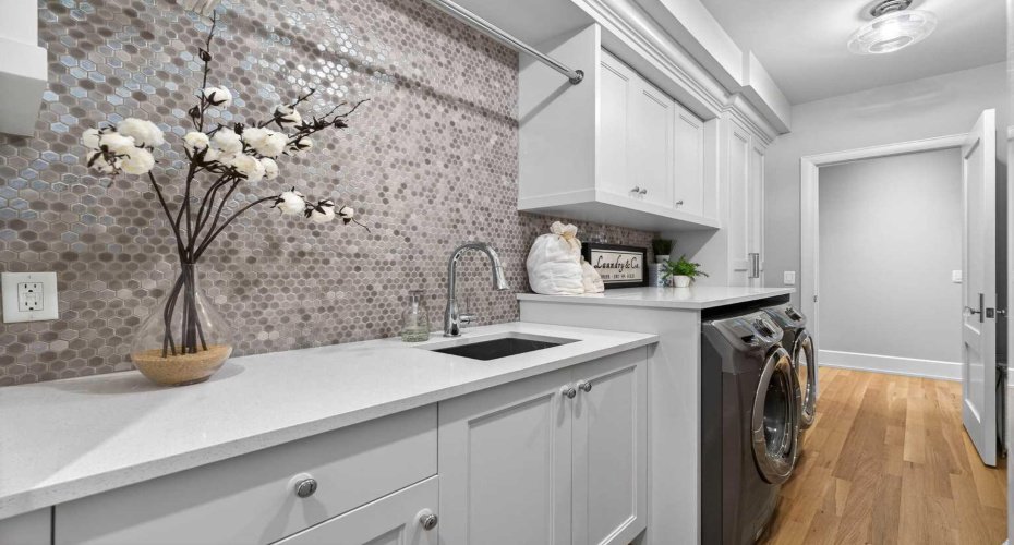 Upper level laundry room with custom cabinetry — convenience where it matters most.