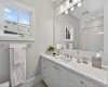 Bright ensuite with modern finishes — heated floors throughout all bathrooms in this home.