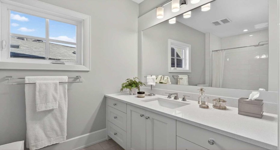 Bright ensuite with modern finishes — heated floors throughout all bathrooms in this home.