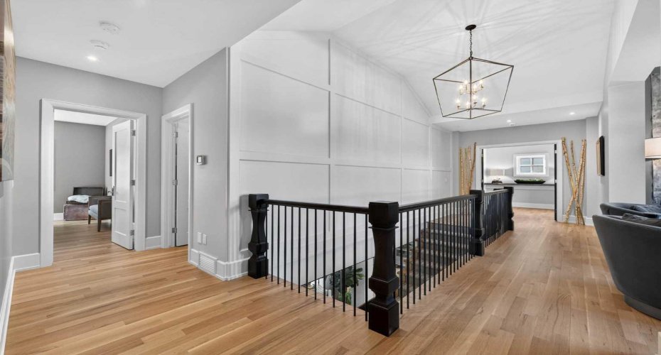 Upper level landing with natural light — connecting the bedrooms, bonus room, and laundry.