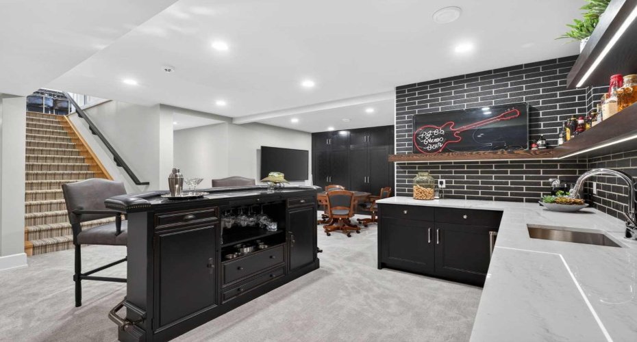 Fully developed lower level with wet bar, custom cabinetry, and premium audio and mood lighting throughout.