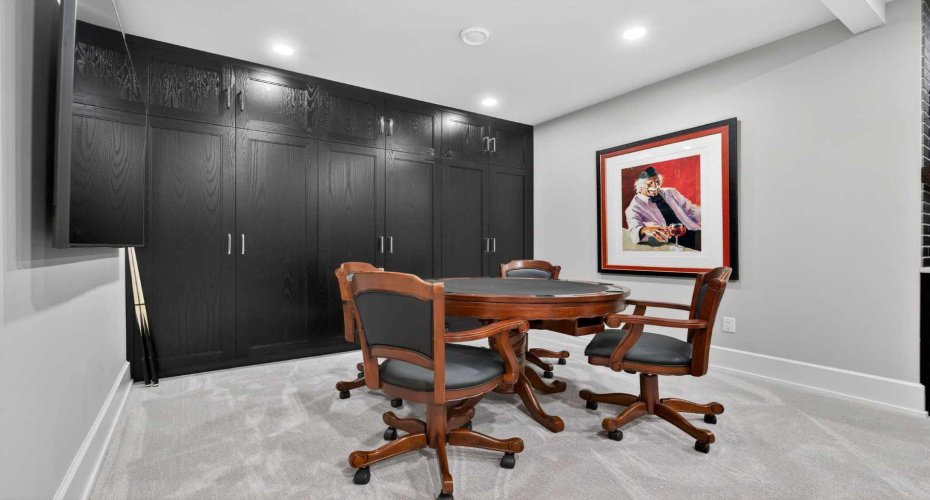 Games area with added millwork for seamless storage — designed for entertaining in style.