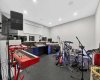 Versatile room with custom-built desk — currently a music studio, equally suited as gym, office, or bedroom.
